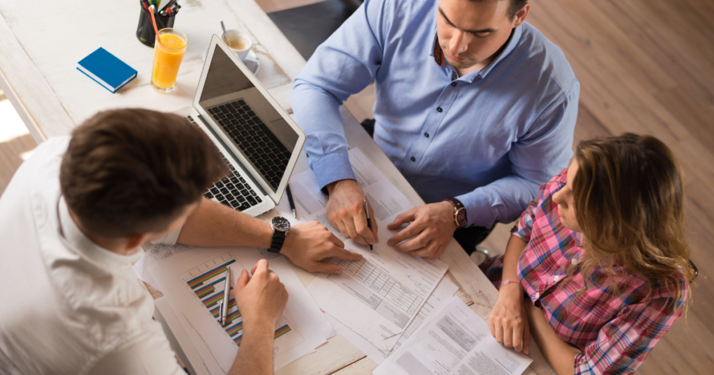 agent working with couple at desk