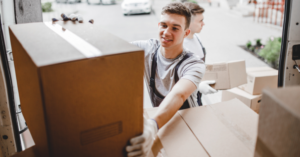 young men moving boxes